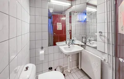 a white bathroom with a sink and a toilet at Lovely Home In Hamar With Wifi in Hamar