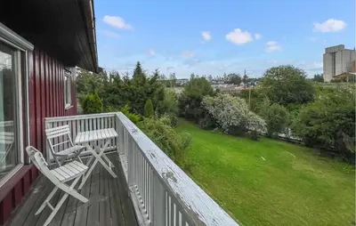 a balcony with a white bench on a house at Lovely Home In Hamar With Wifi in Hamar