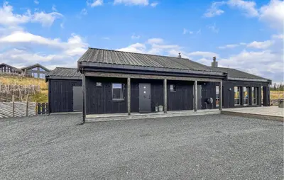 a large black building with a lot of windows at Cozy Home In Svingvoll With House A Mountain View in Svingvoll