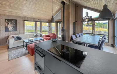 a kitchen and living room with a couch and a table at Cozy Home In Svingvoll With House A Mountain View in Svingvoll