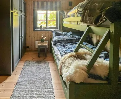 a room with two bunk beds with a rug at Newly Renovated Cabin By Sjusjoen Ski Slopes in Sjusjøen