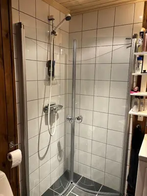 a shower with a glass door in a bathroom at Cosy ski-in ski-out mountain cabin with sauna in Trysil