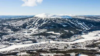 an aerial view of a city with a snow covered mountain at Cosy ski-in ski-out mountain cabin with sauna in Trysil