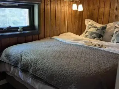 a bedroom with a bed with glasses on it at Luxury Mountain Cabin with Hot Tub and Views in Budal in Storen