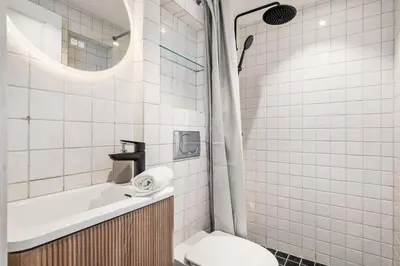 a bathroom with a toilet and a sink and a shower at Spacious Gem In Old Town I NEW 2025 I 3 Bed 2 Bath in Bergen