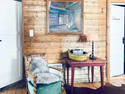 a wooden wall with a table and a desk with a chair at Traditional Cabin With Annex In The Mountains in Gol