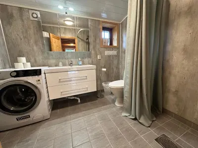 a bathroom with a washing machine and a sink at Bjorliheimen Fjellhotell-Hytte 11 & 12 in Bjorli