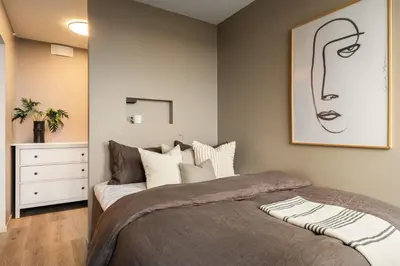 a bedroom with a bed and a painting on the wall at Spectacular view 2 roms apartment in Bergen