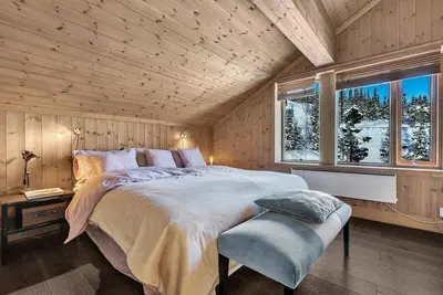 a bedroom with a large bed and a window at Lodge With Views Of Gaustatoppen Mountain in Rjukan