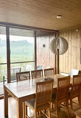 a dining room with a large wooden table and chairs at Lodge With Views Of Gaustatoppen Mountain in Rjukan