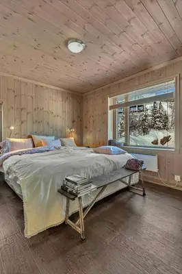 a bedroom with a large bed and a window at Lodge With Views Of Gaustatoppen Mountain in Rjukan