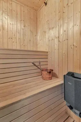 a wooden sauna with a basket in the corner at Lodge With Views Of Gaustatoppen Mountain in Rjukan