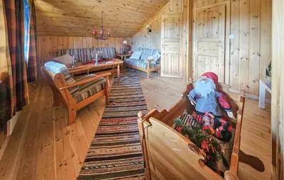 a living room of a cabin with a santa clause at 4 Bedroom Stunning Home In Tuddal in Tuddal