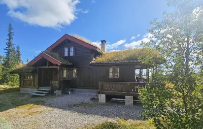 a log cabin with a grass roof on top of it at 4 Bedroom Stunning Home In Tuddal in Tuddal