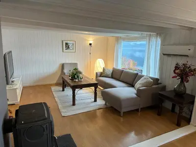 a living room with a couch and a table at Sauda 4 bedrooms near skiing with view of fjord in Sauda