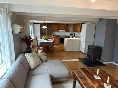 a living room with a couch and a table at Sauda 4 bedrooms near skiing with view of fjord in Sauda