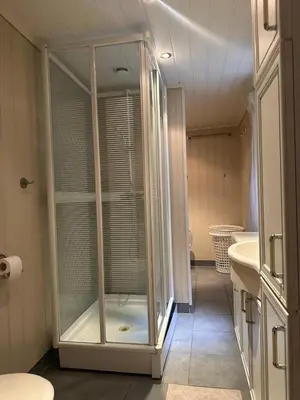 a bathroom with a glass shower and a sink at Sauda 4 bedrooms near skiing with view of fjord in Sauda
