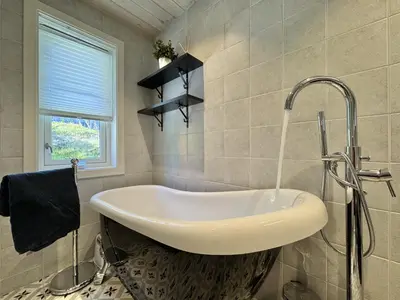a bathroom with a sink and a window at Bjørnebo, Family cabin in Torpo