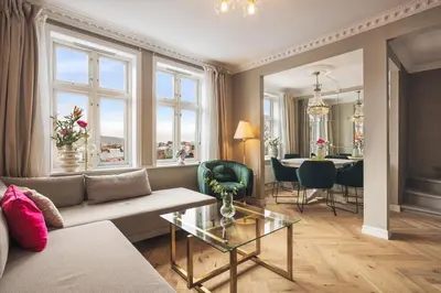 a living room with a couch and a table at Exclusive & Charming Apartment in Bergen