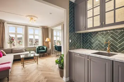 a kitchen and living room with a couch and a table at Exclusive & Charming Apartment in Bergen