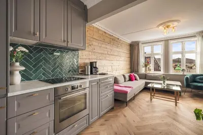 a kitchen and a living room with a couch at Exclusive & Charming Apartment in Bergen
