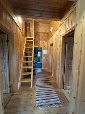 a room with a staircase in a wooden house at Bjorliheimen Fjellhotell-Hytte 4 og 16 in Bjorli