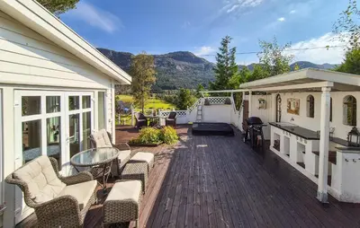 a wooden deck with chairs and a table on a house at Stunning Home In Vikebygd With House A Mountain View in Vikebygd