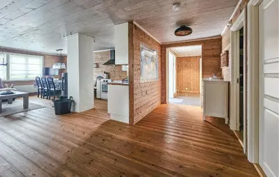 a kitchen and living room with wooden floors and a table at Amazing Home In Veggli With Wifi in Veggli