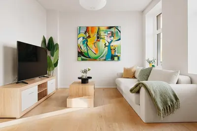 a living room with a white couch and a tv at DINBNB Apartment l 200m to Torgallmenningen l High-End Bergen Stay l Steps from Center in Bergen
