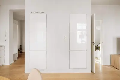 a room with white walls and white doors at DINBNB Apartment l 200m to Torgallmenningen l High-End Bergen Stay l Steps from Center in Bergen