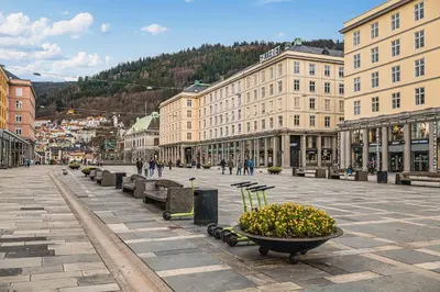 a city street with buildings and a pot of flowers at DINBNB Apartment l 200m to Torgallmenningen l High-End Bergen Stay l Steps from Center in Bergen