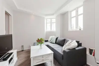 a living room with a couch and a table at Pepes Apartment in Bergen