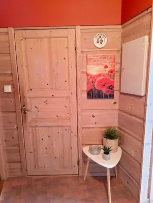 a room with a wooden door and a table at Retreat Øklandsnes in Lii