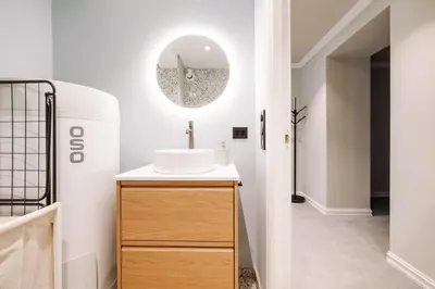 a bathroom with a sink and a mirror at Large city apartment with sea view and parking in Ålesund