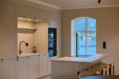 a kitchen with a sink and a counter with a window at Large city apartment with sea view and parking in Ålesund