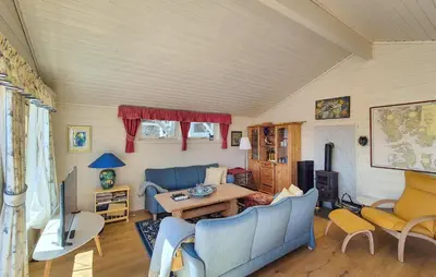 a living room with blue couches and a table at 4 Bedroom Gorgeous Home In Steinsland in Steinsland