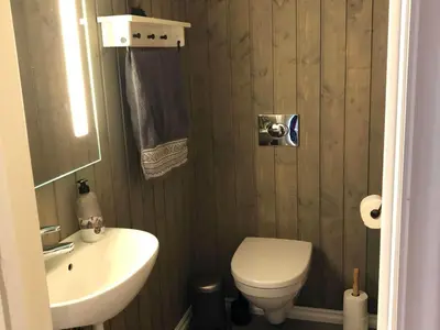 a bathroom with a white toilet and a sink at 12 person holiday home in Skare-By Traum in Skare