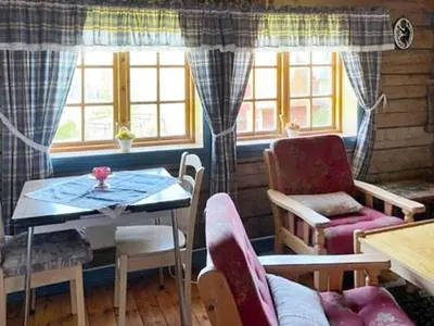 a living room with a table and chairs and windows at 4 person holiday home in Bryggja-By Traum in Bryggja