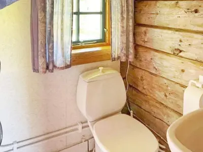 a bathroom with a toilet and a sink and a window at 4 person holiday home in Bryggja-By Traum in Bryggja