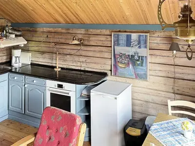 a kitchen with a stove and a table with a table sidx sidx at 4 person holiday home in Bryggja-By Traum in Bryggja