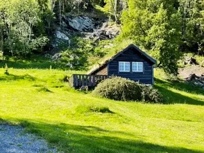 a small cabin in the middle of a green field at 4 person holiday home in Bryggja-By Traum in Bryggja