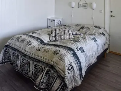 a bed in a bedroom with a blanket on it at 6 person holiday home in Onarheim in Onarheim