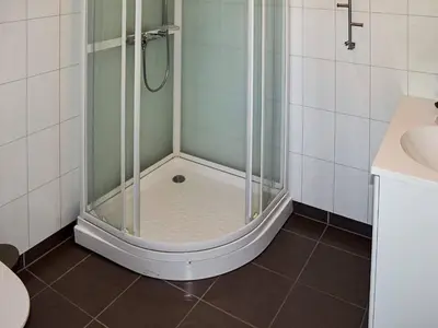 a shower with a glass door in a bathroom at 6 person holiday home in Onarheim in Onarheim