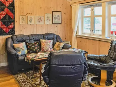 a living room with a leather couch and a table at 8 person holiday home in FREI in Frei