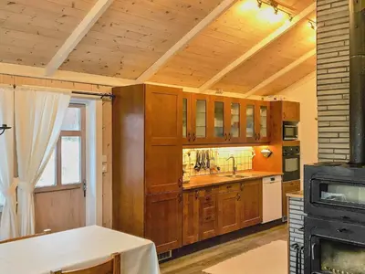 a kitchen with wooden cabinets and a sink and a stove at 8 person holiday home in FREI in Frei
