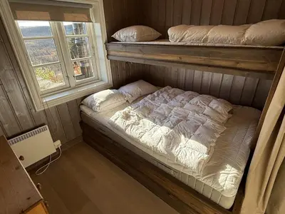 a bedroom with two bunk beds and a window at Great cabin with gorgeous mountain views in Dagali