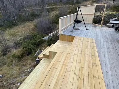 a wooden deck with a bench on top of it at Great cabin with gorgeous mountain views in Dagali