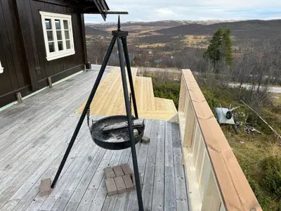 a swing on the deck of a house at Great cabin with gorgeous mountain views in Dagali