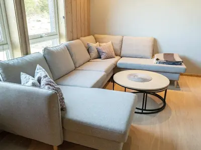 a living room with a couch and a table at 10 person holiday home in INDERØY-By Traum in Kjerkenesvåg