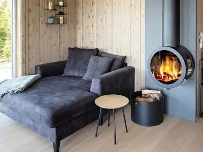 a living room with a couch and a fire place at 10 person holiday home in INDERØY-By Traum in Kjerkenesvåg